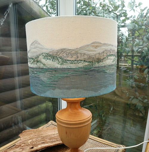 embroidered picture of lake and mountains on lampshade